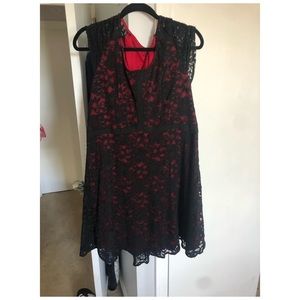 Evening black lace dress over red fabric